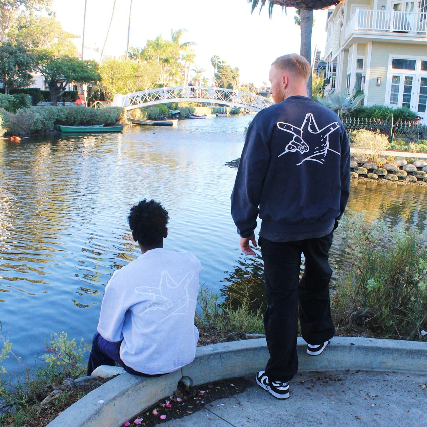 Ash Grey Hands Sweater (left) Dolphin Blue Hands Sweater (right)